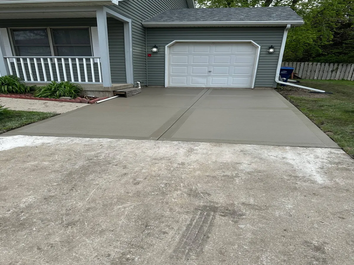 New concrete driveway poured and finished in front of a home